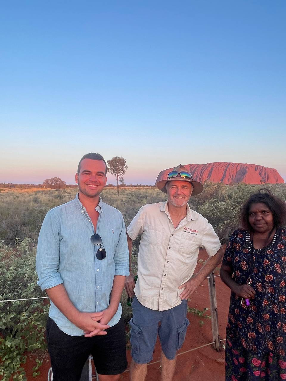 The Red Spaces team with a local Anangu guide at Uluru at sunset